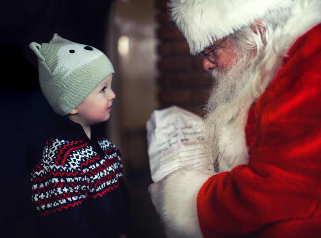 toddler talking to a Santa Claus